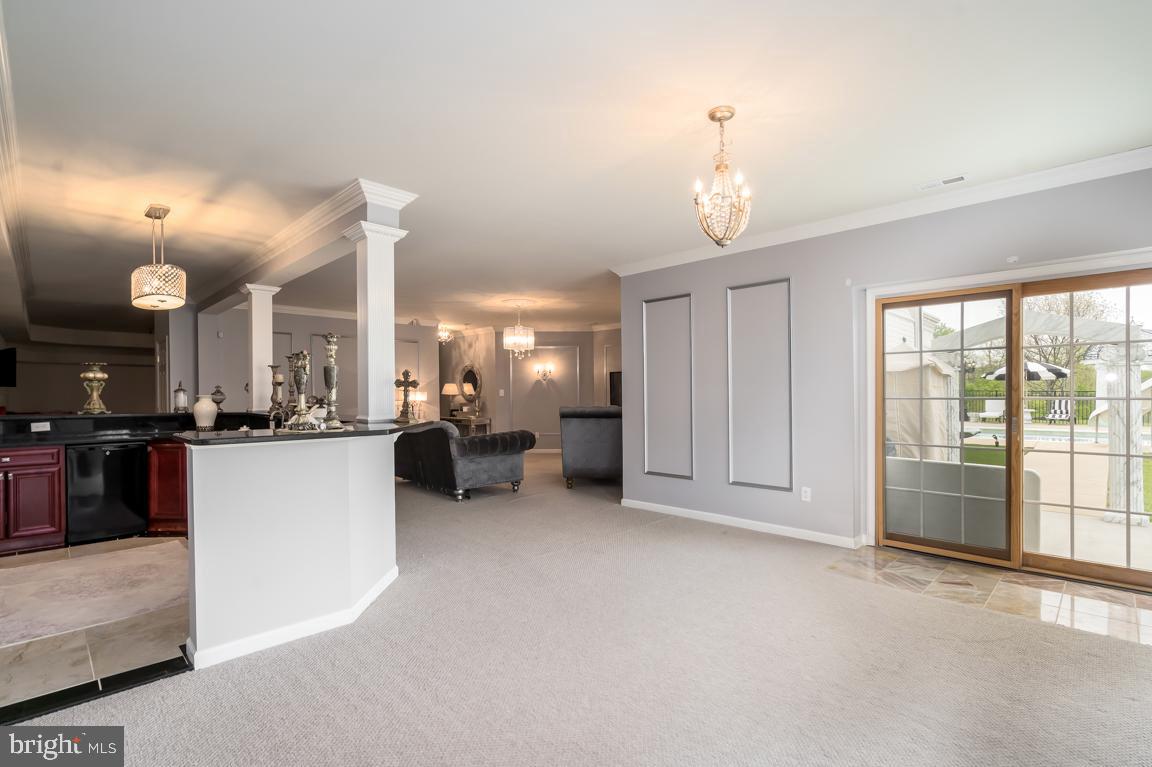 6779 Keller Lime Plant Road Frederick, MD 21703 - Photo 64 of 74 a view of a living room and kitchen with furniture a chandelier