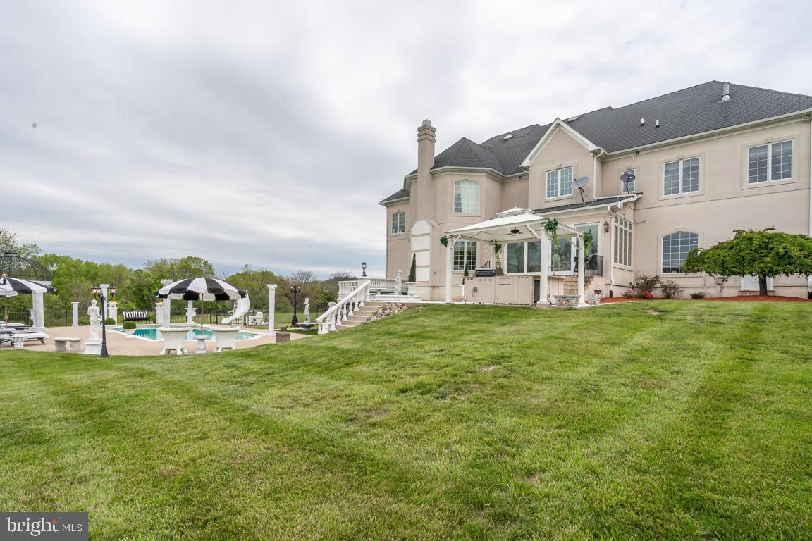 6779 Keller Lime Plant Road Frederick, MD 21703 - Photo 71 of 74 a view of a white house with a big yard and large trees