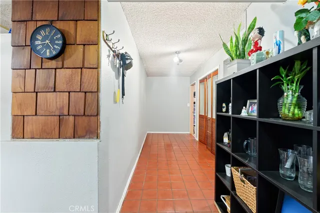 a view of entryway with paintings on the wall