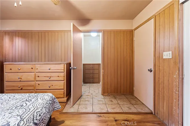 a bedroom with a bed and a mirror