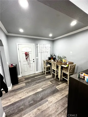 a living room with furniture gym equipment and a flat screen tv