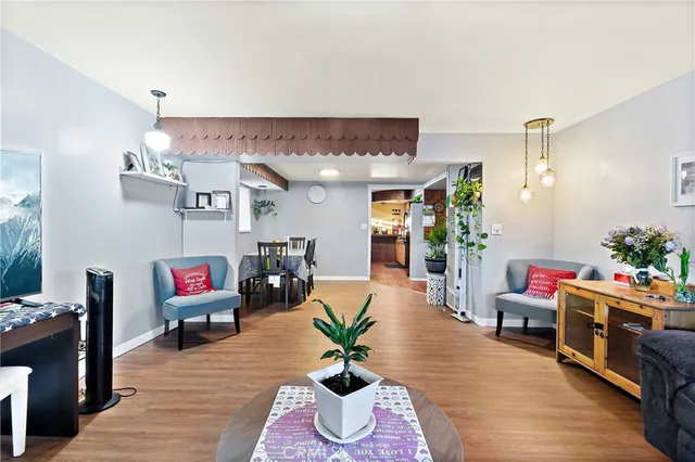a living room with furniture gym equipment and a potted plant