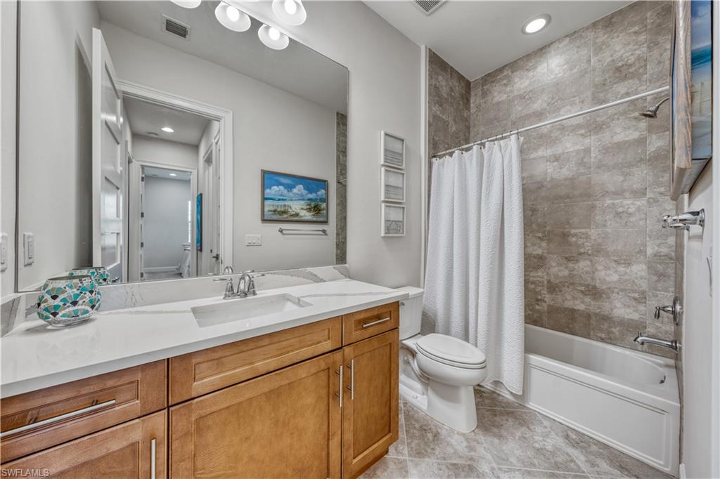6421 Carnival Road Naples, FL 34113 - Photo 22 of 28 a bathroom with a sink a toilet and shower