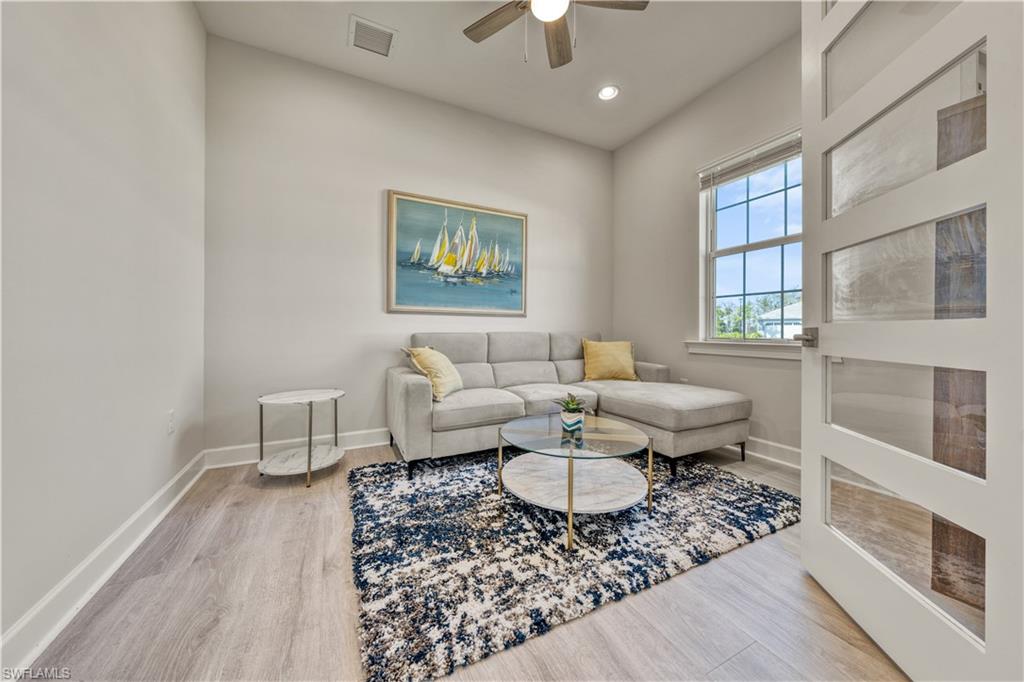 6421 Carnival Road Naples, FL 34113 - Photo 23 of 28 a living room with furniture and a rug