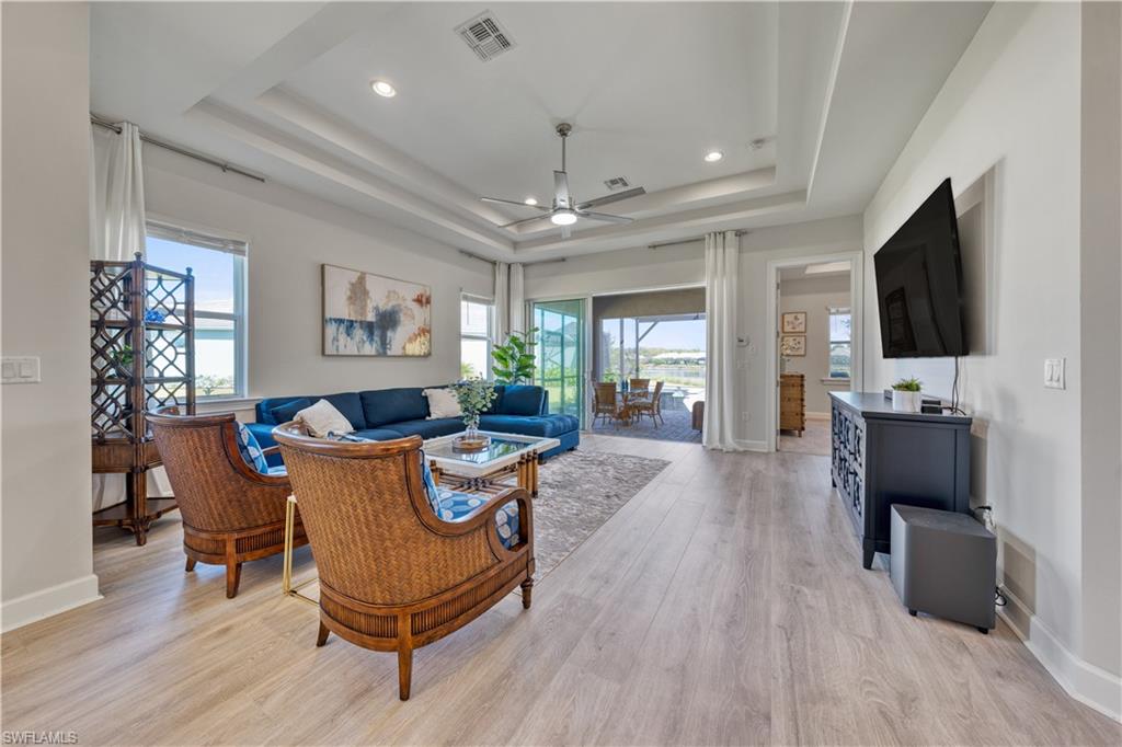 6421 Carnival Road Naples, FL 34113 - Photo 3 of 28 a living room with furniture and a flat screen tv