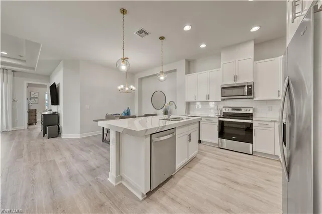 a kitchen with a sink stainless steel appliances and cabinets