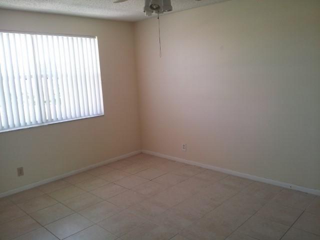 8761 Wiles Road, Unit 303 Coral Springs, FL 33067 - Photo 3 of 5 an empty room with a window