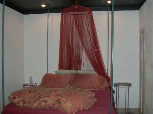 a bedroom with a bed and a mirror