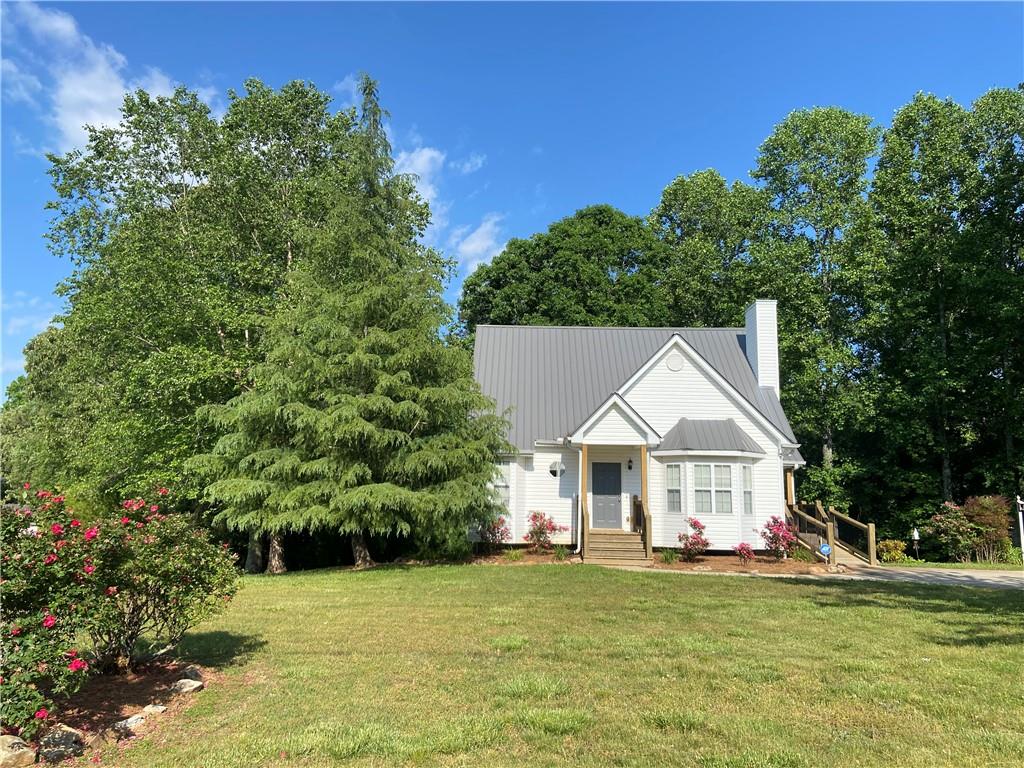 5970 Heardsville Road Cumming, GA 30028 - Photo 1 of 1 a view of a house with a yard and sitting area