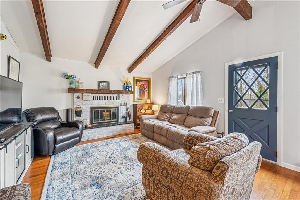 2095 Rocky Ridge Road Acme, PA 15610 - Photo 4 of 33 a living room with furniture a fireplace and a flat screen tv