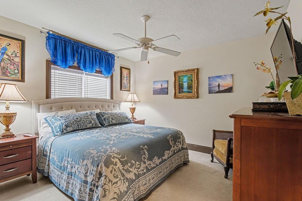 6662 Southwest 179th Ave Road Dunnellon, FL 34432 - Photo 20 of 51 a bedroom with a large bed and a chandelier