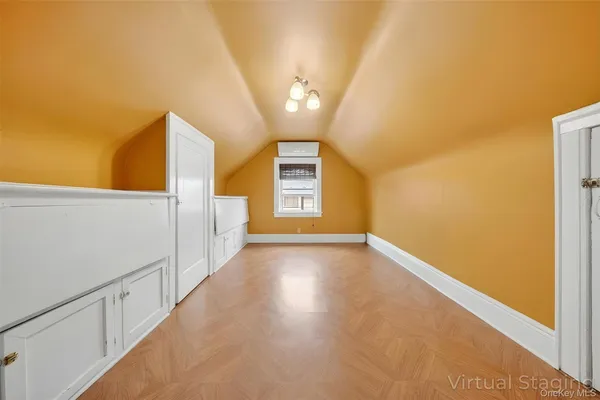 a view of a big room with wooden floor and brick walls