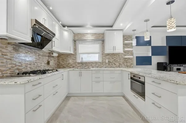 a kitchen with stainless steel appliances kitchen island granite countertop a refrigerator and a stove top oven