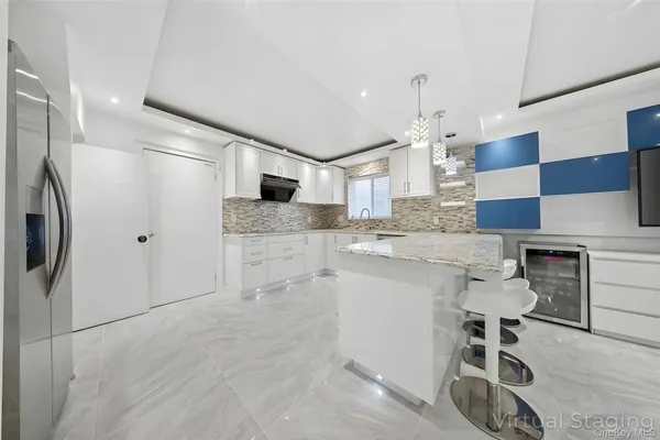 a kitchen with granite countertop a sink and a stove top oven