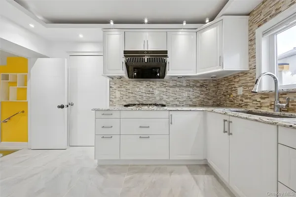 a bathroom with a glass shower door and a mirror