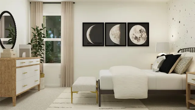 a bedroom with a bed and painting on the wall