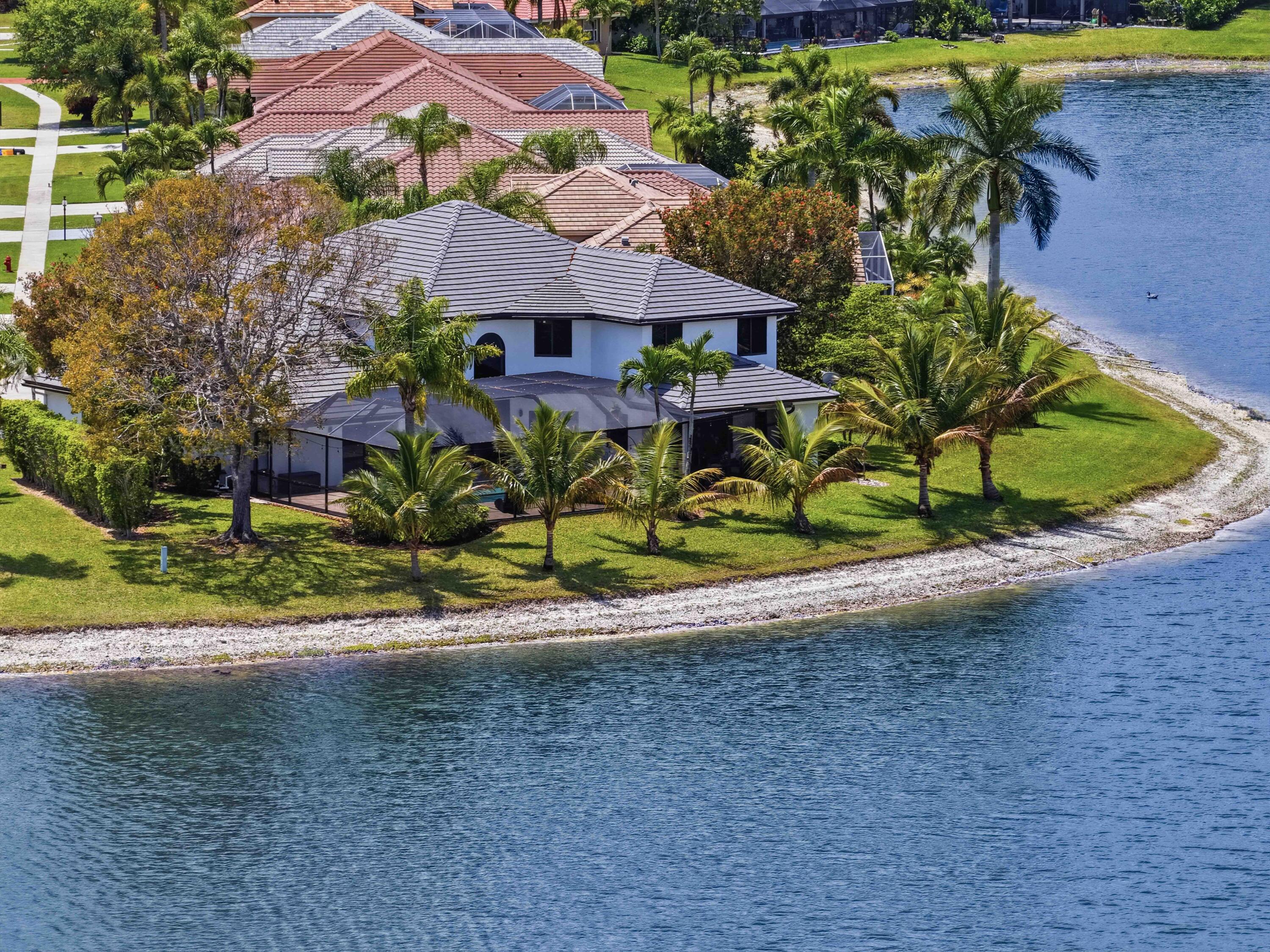 22257 Vista Lago Drive Boca Raton, FL 33428 - Photo 11 of 82 a view of a house with a yard and plants