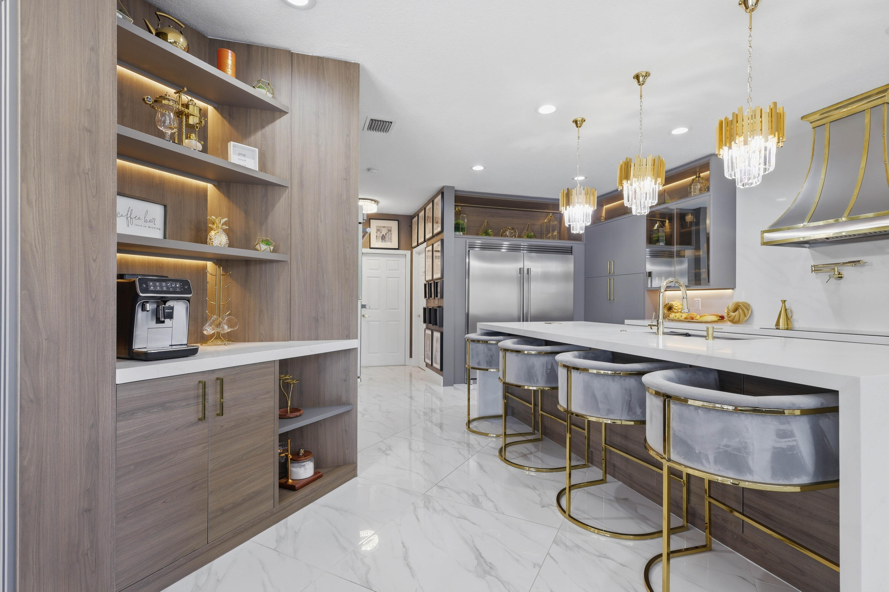 22257 Vista Lago Drive Boca Raton, FL 33428 - Photo 27 of 82 a kitchen with stainless steel appliances granite countertop a table chairs sink and cabinets