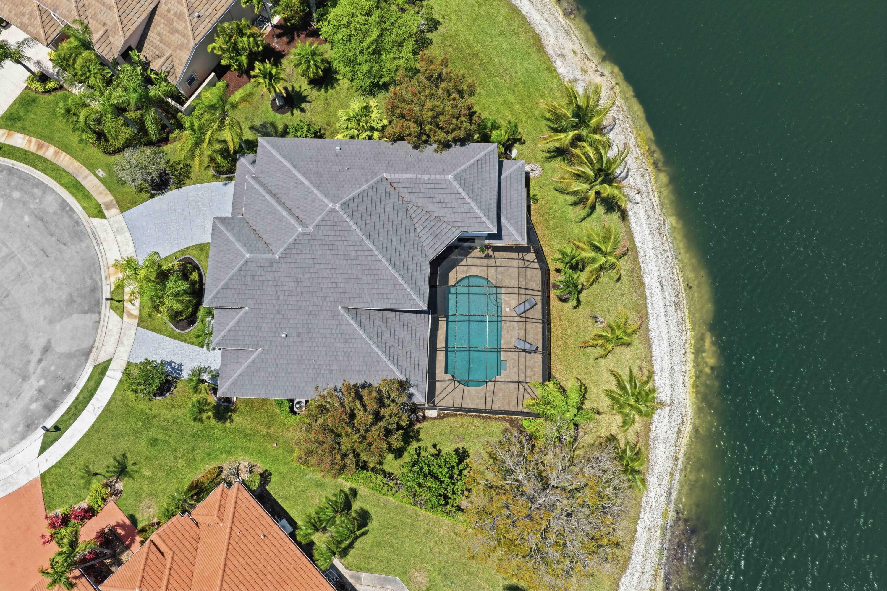 22257 Vista Lago Drive Boca Raton, FL 33428 - Photo 3 of 82 an aerial view of a house with a yard and swimming pool