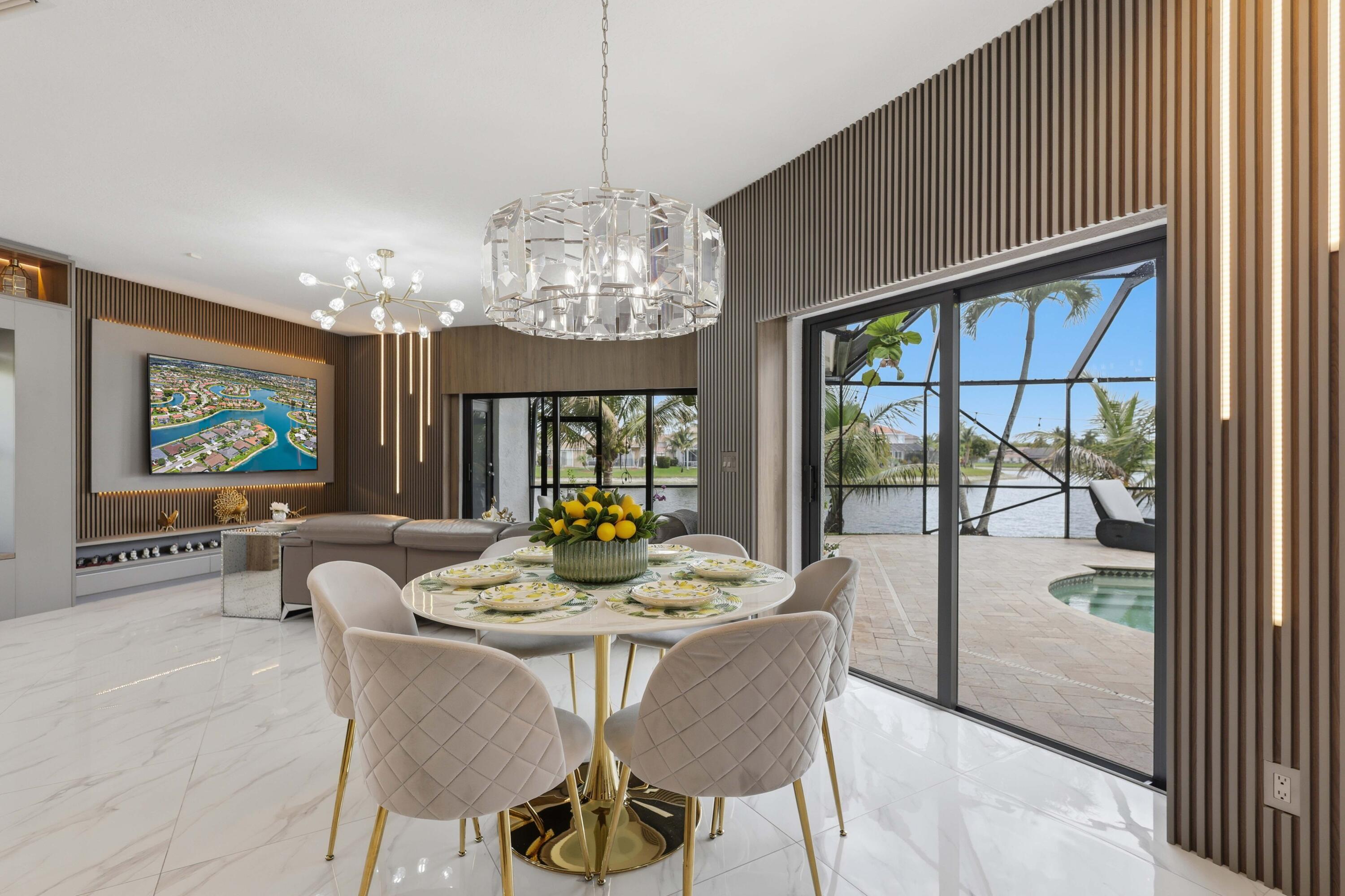 22257 Vista Lago Drive Boca Raton, FL 33428 - Photo 31 of 82 a view of a dining room with furniture a chandelier and wooden floor