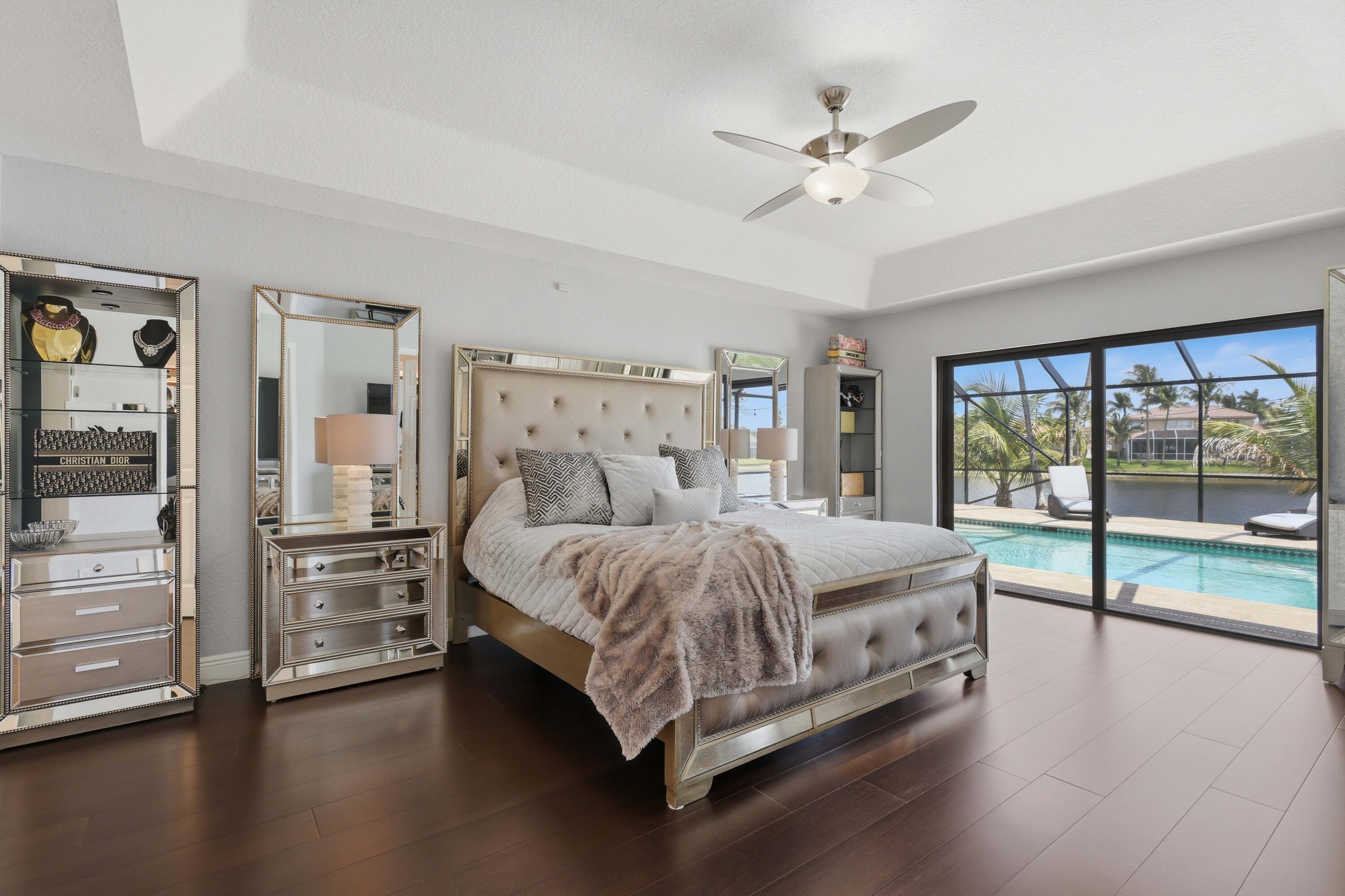 22257 Vista Lago Drive Boca Raton, FL 33428 - Photo 48 of 82 a spacious bedroom with a bed and large window with balcony view