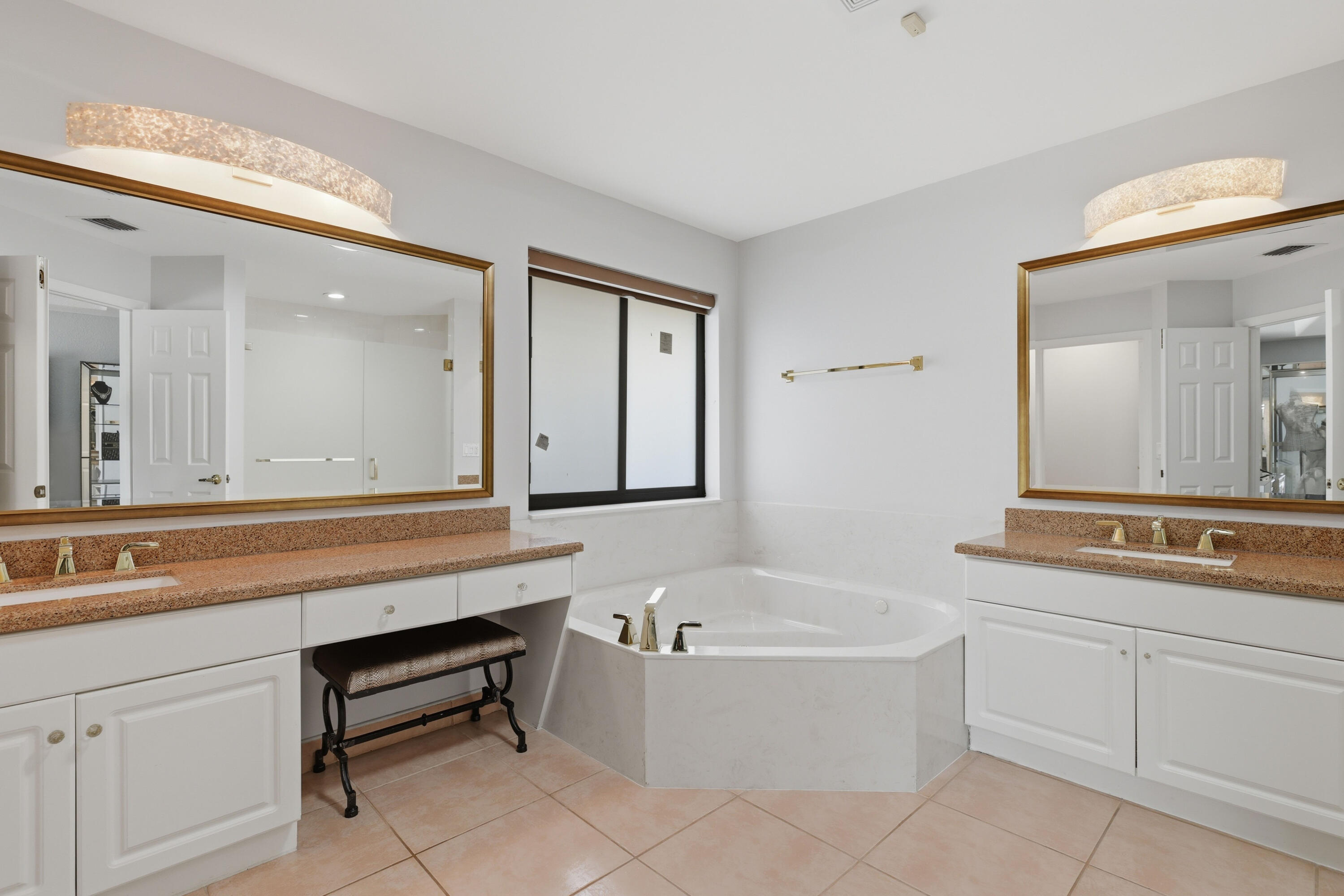 22257 Vista Lago Drive Boca Raton, FL 33428 - Photo 50 of 82 a bathroom with a bathtub a sink and a mirror