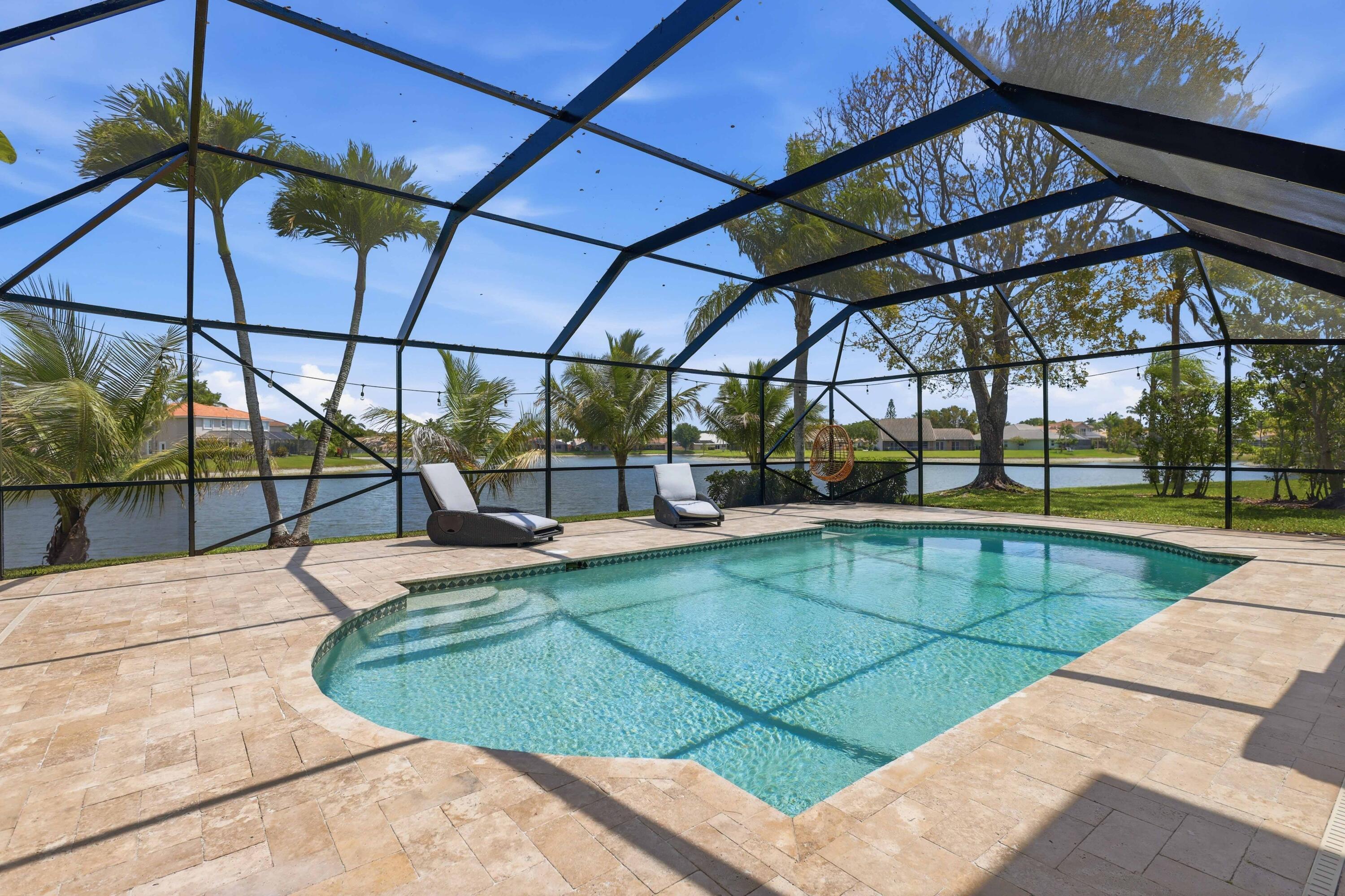 22257 Vista Lago Drive Boca Raton, FL 33428 - Photo 51 of 82 a view of a swimming pool with a patio