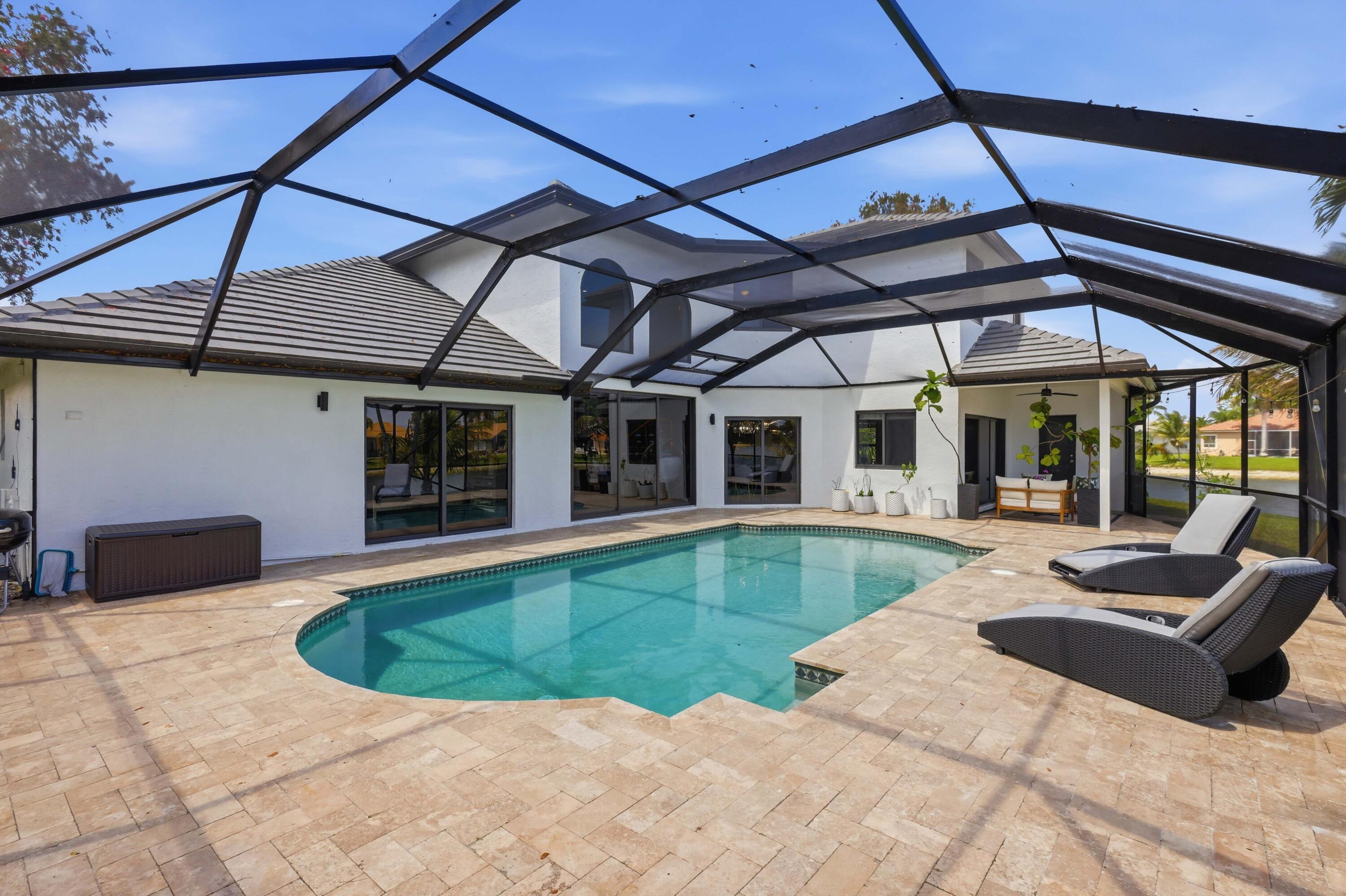 22257 Vista Lago Drive Boca Raton, FL 33428 - Photo 55 of 82 a view of a house with backyard porch and sitting area