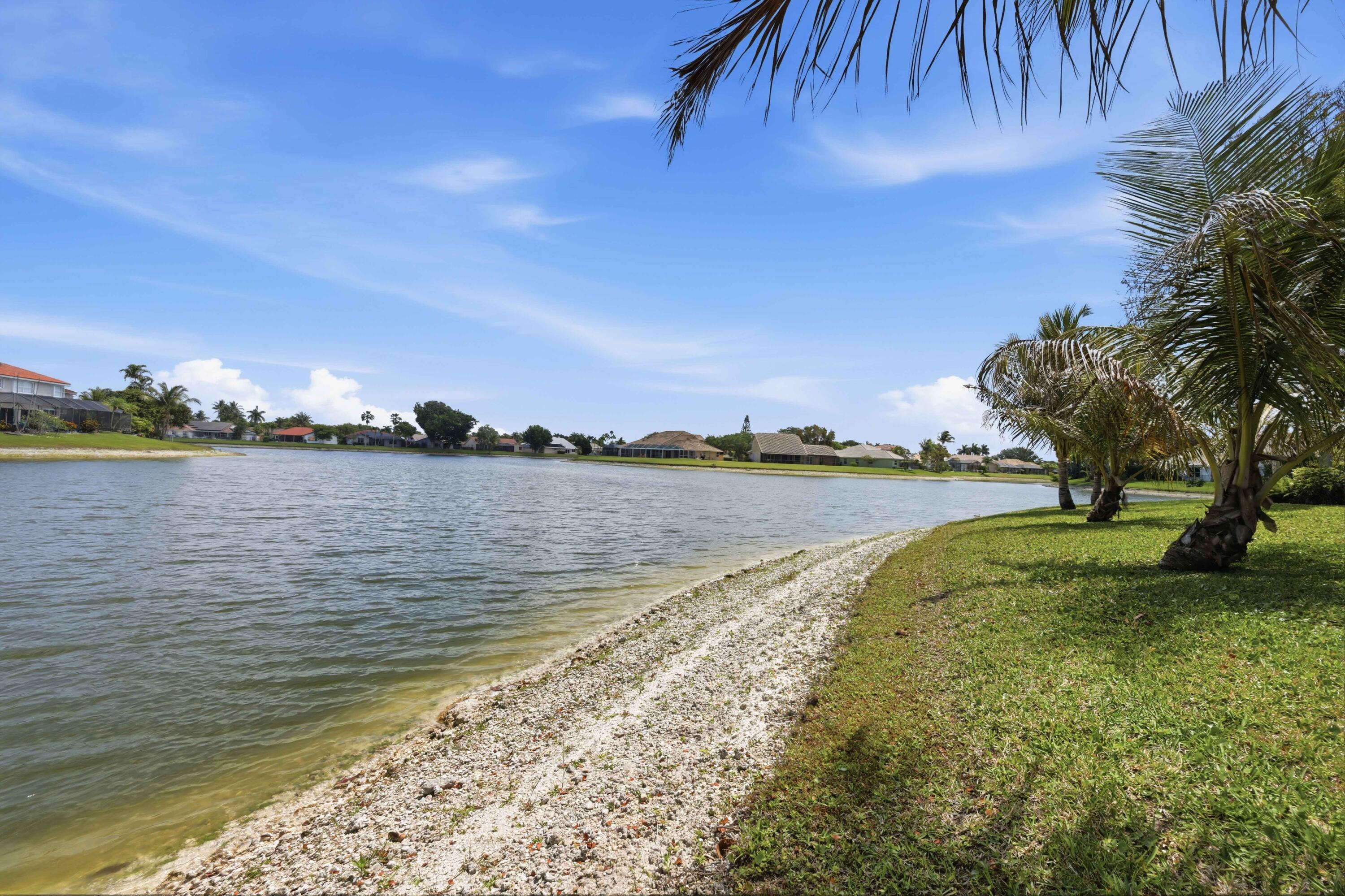 22257 Vista Lago Drive Boca Raton, FL 33428 - Photo 57 of 82 a view of a lake with a yard