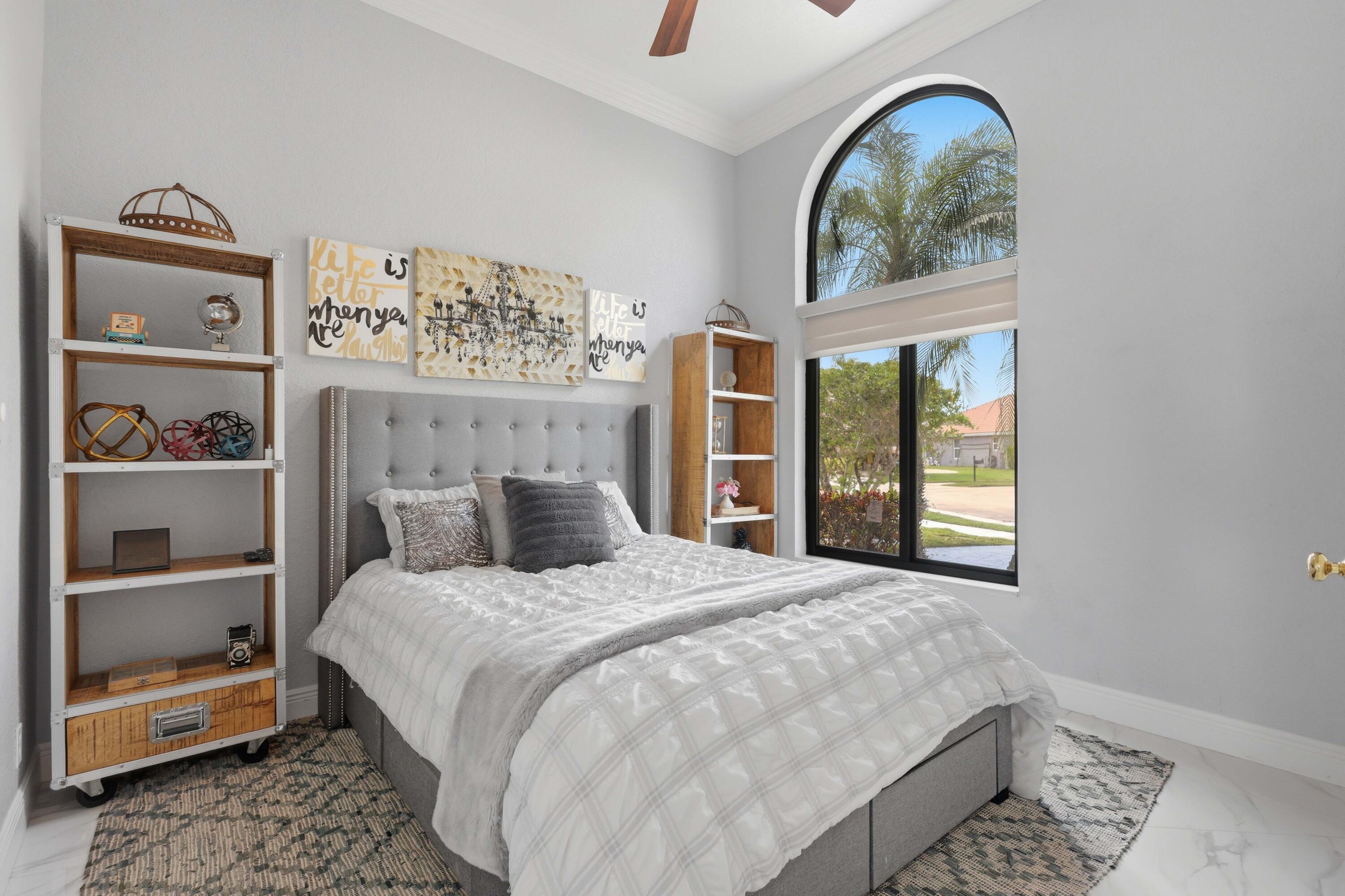 22257 Vista Lago Drive Boca Raton, FL 33428 - Photo 62 of 82 a bedroom with a bed and a window