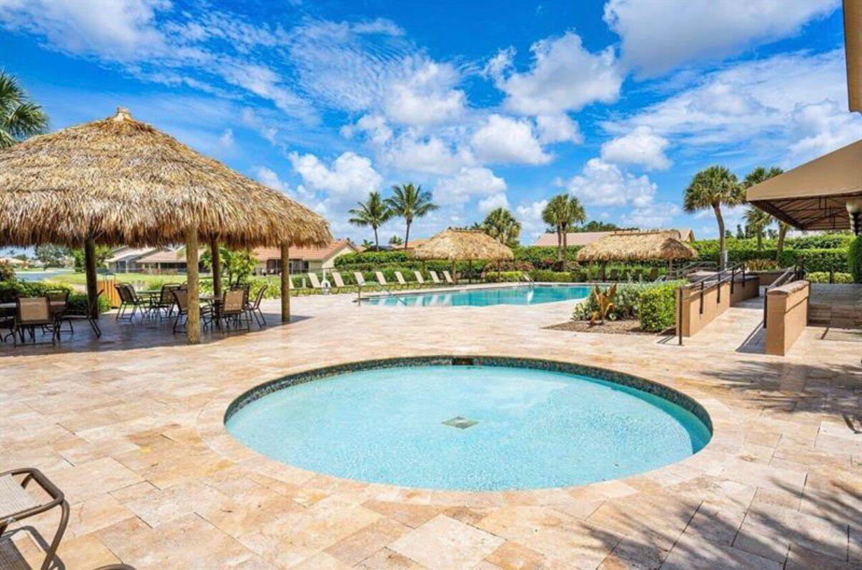 22257 Vista Lago Drive Boca Raton, FL 33428 - Photo 70 of 82 a view of a swimming pool with a patio