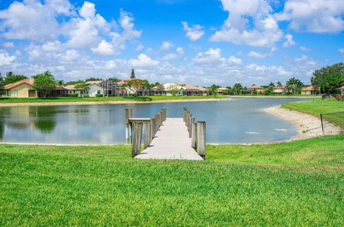 22257 Vista Lago Drive Boca Raton, FL 33428 - Photo 73 of 82 an aerial view of a house with a lake view and a large tree