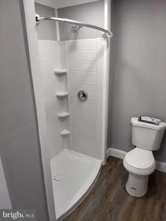 a bathroom with a toilet and a shower