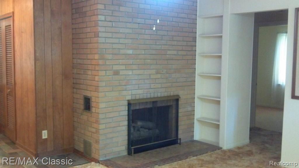 2744 Loon Lake Road Wixom, MI 48393 - Photo 5 of 6 Living Room with Gas Fireplace and Built-Ins