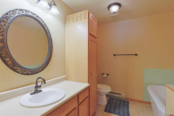 a bathroom with a sink a toilet and a mirror