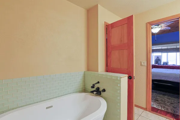 a bathroom with a tub and shower