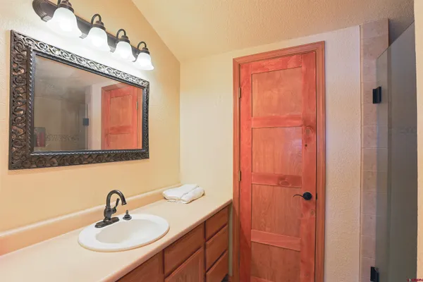 a bathroom with a sink vanity and mirror