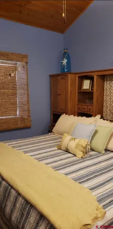 a bedroom with a bed and dresser