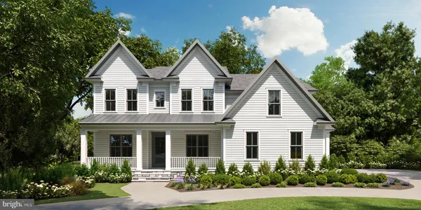 a view of a white house with large windows and a small yard