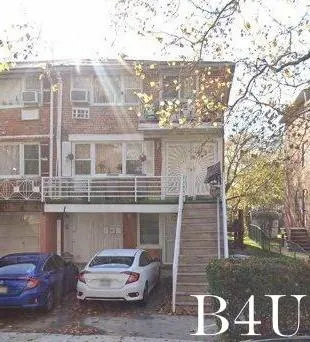 a car parked in front of a brick house