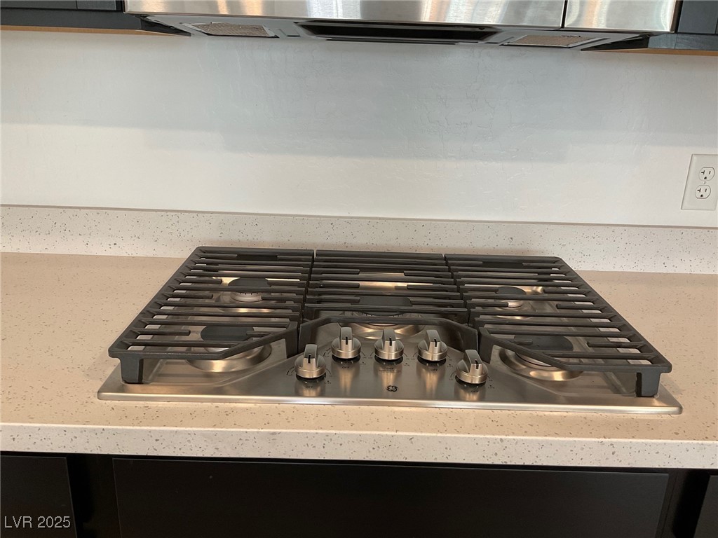 2555 Hampton Road, Unit 4209 Henderson, NV 89052 - Photo 16 of 67 Kitchen view of stainless steel gas cooktop, range hood, and light stone counters