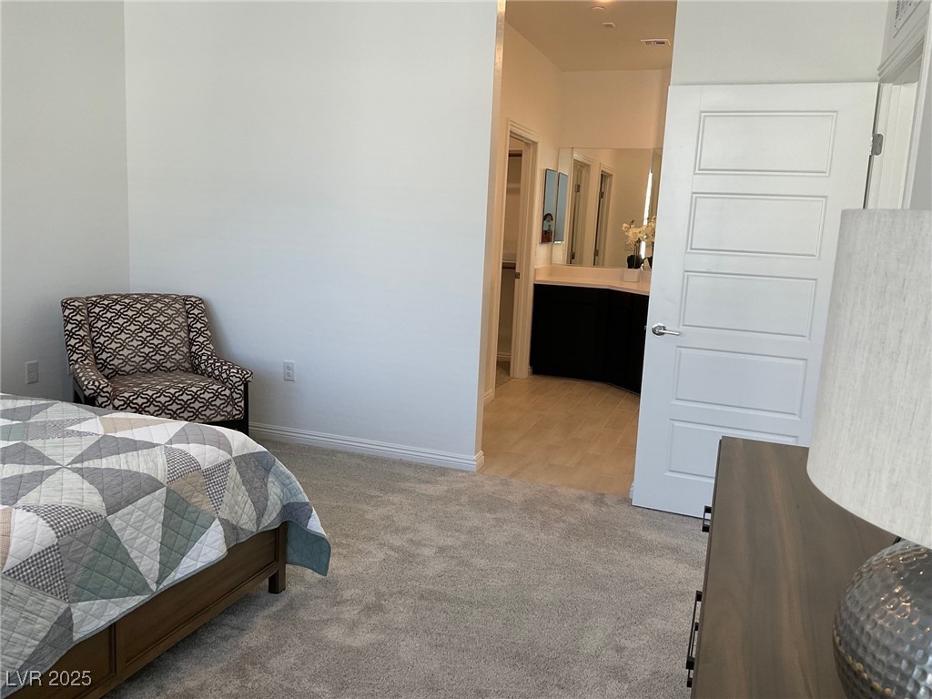 2555 Hampton Road, Unit 4209 Henderson, NV 89052 - Photo 31 of 67 Bedroom with light colored carpet and connected bathroom