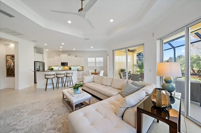 a kitchen with a dining table chairs and white cabinets