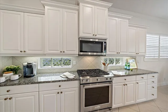 a living room with granite countertop furniture and a refrigerator