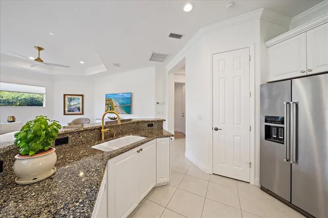 a kitchen with granite countertop a sink and cabinets