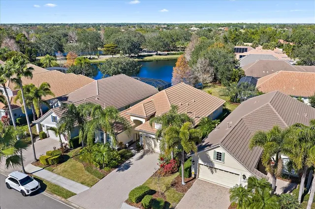 an aerial view of a house with yard swimming pool and outdoor seating
