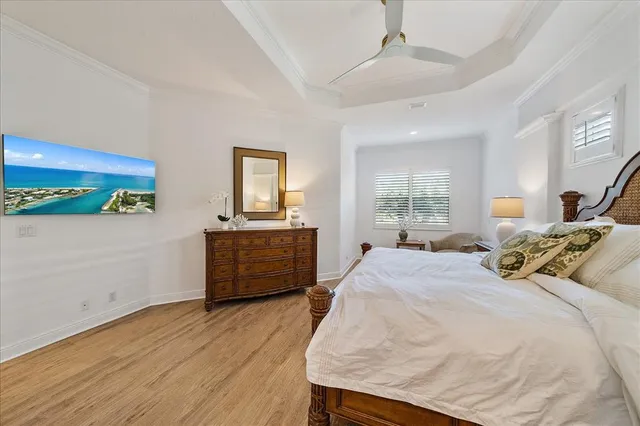 a bedroom with a bed wooden floor and window