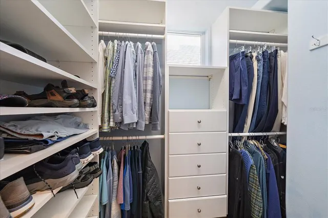 a spacious bathroom with a double vanity sink mirror and bathtub