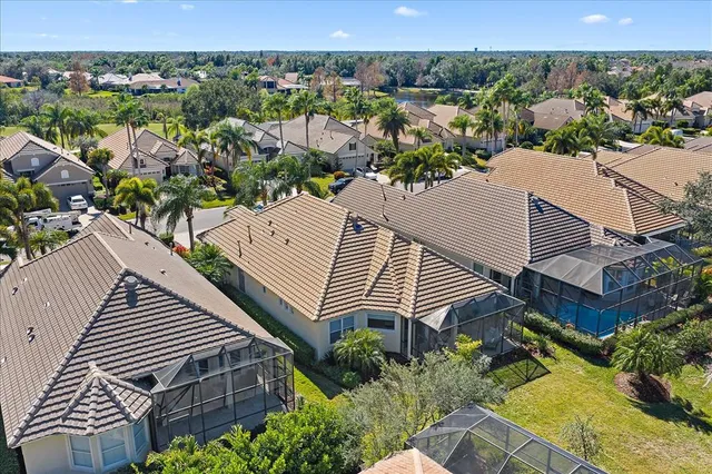 an aerial view of a house with a yard and outdoor seating