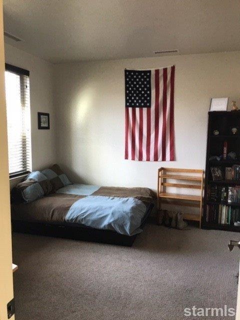 3681 Warren Way, Unit C Reno, NV 89509 - Photo 7 of 11 a bedroom with a bed and a cabinet